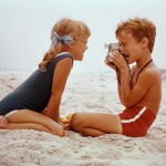 Boy Photographs Girl on Beach