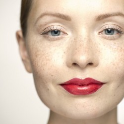 Young woman wearing bright red lipstick, portrait