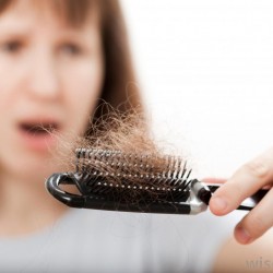 woman-with-hair-loss-looking-at-brush